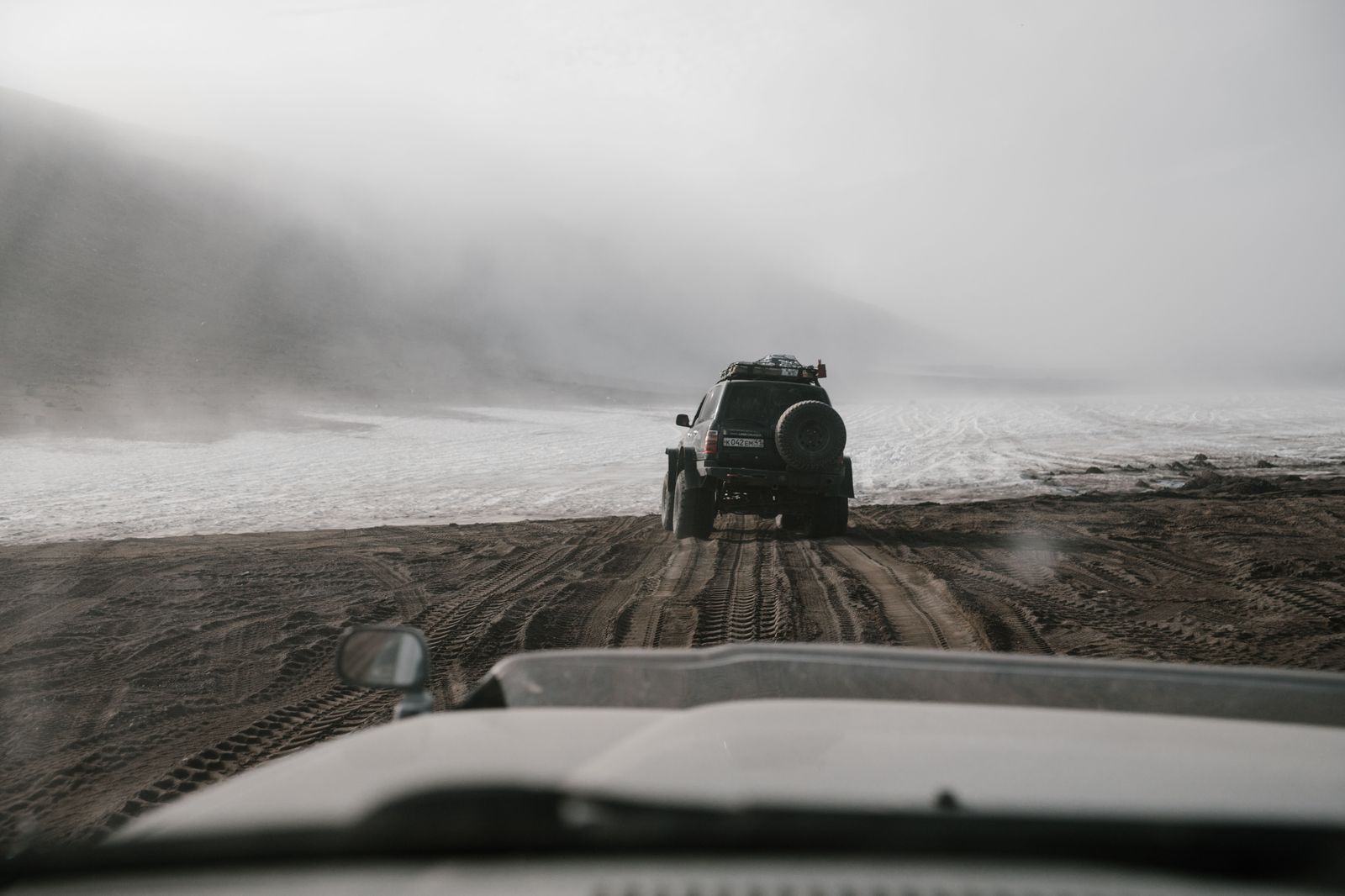 A black SUV on a snowy highway: winter tires from November and a chauffeur trained for the 401