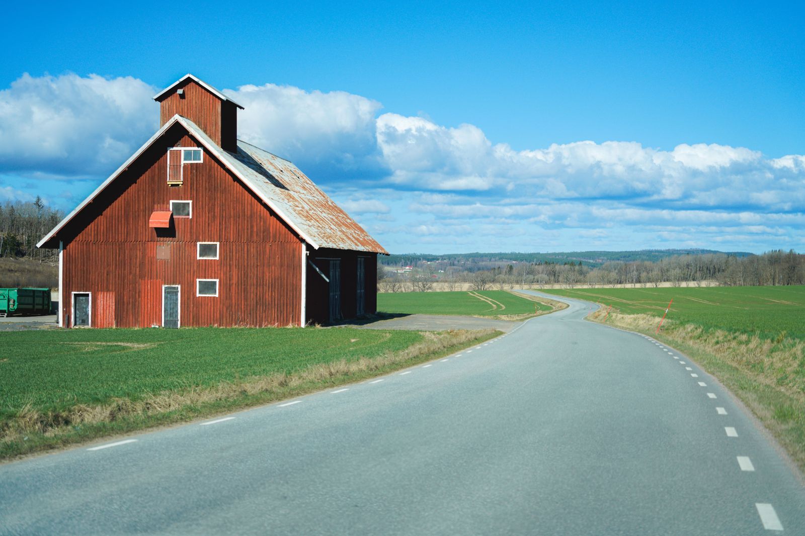 A county road through Kent's farmland: the richest agricultural land in the province, and the greenhouses on the horizon