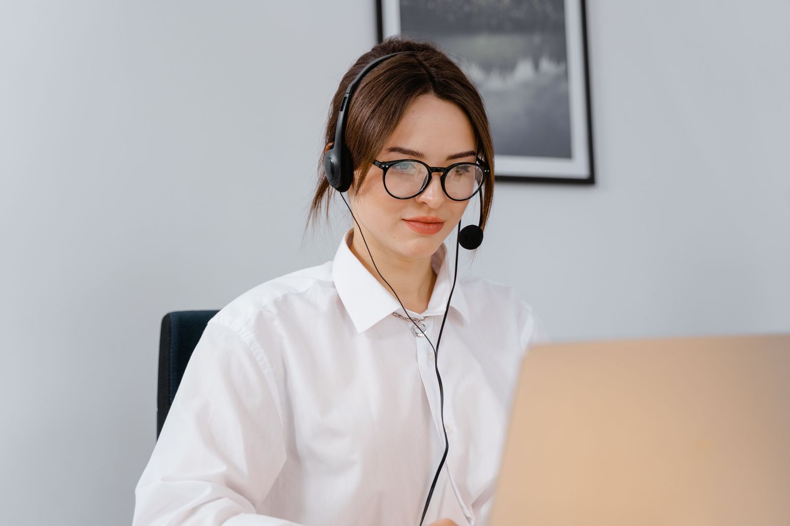 An executive assistant books a chauffeur from a corporate account on a laptop