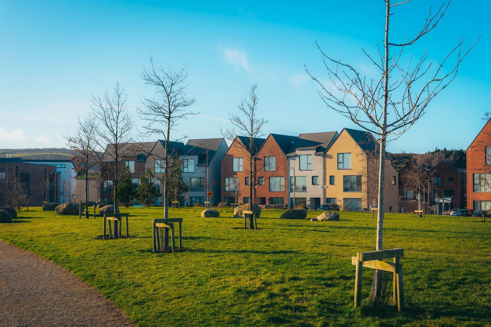 A new subdivision at dusk: Sunningdale, Hyde Park and Riverbend are the city's growing edges, and the airport run is the same fixed rate